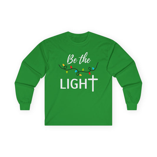 Front view of Be the Light Christian t-shirt with Christmas lights design — faith-based holiday shirt inspired by perfect Christmas Christ gift.